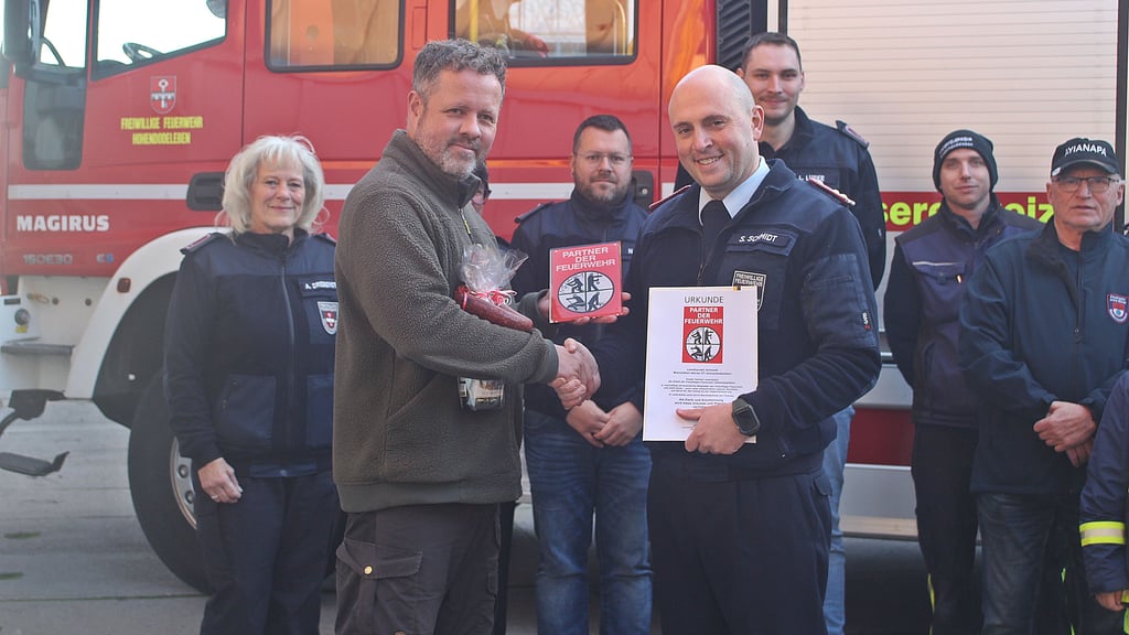 Im Beisein einiger Feuerwehrkameraden, darunter Maurice Schmid (hinten 2. von rechts), überreichte Ortswehrleiter Sascha Schmidt (vorn rechts) die Plakette an Stefan Schmidt.