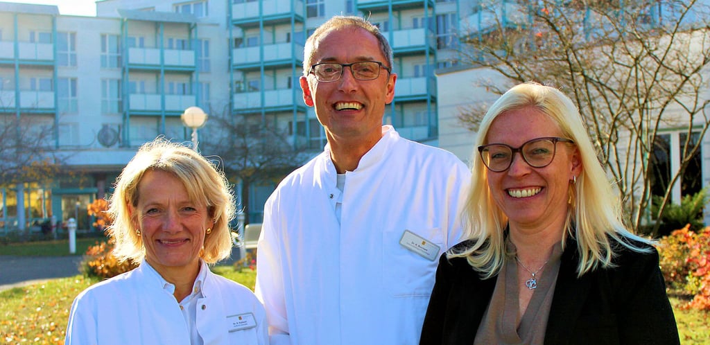 Dr. Kerstin Rohkohl, Chefärztin Orthopädie (links); Dr. Kersten Borchert, Chefarzt Onkologie/Pneumologie und Klinikleiterin Michaela Seils vor der Waldburg-Zeil Klinik in Bad Salzelmen. 