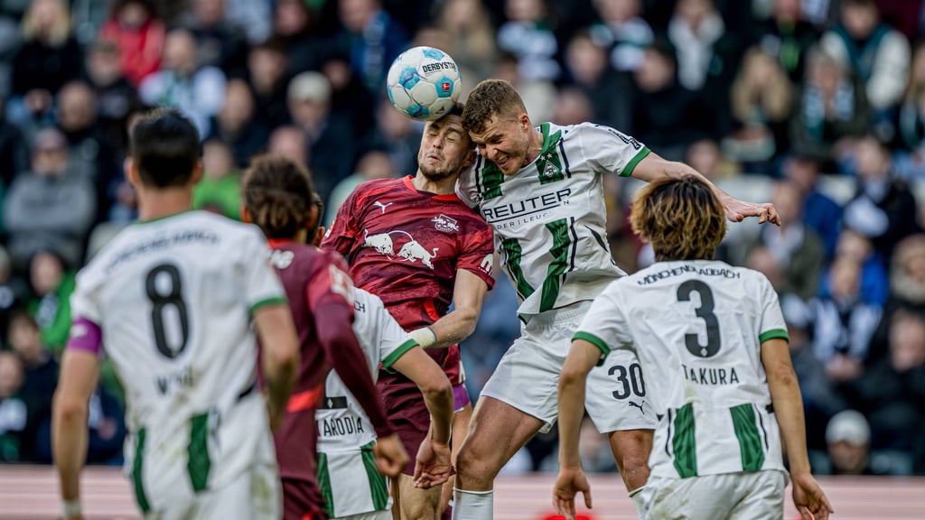 Leipzigs Christoph Baumgartner (rot) im Kopfballduell mit Gladbachs Nico Elvedi.