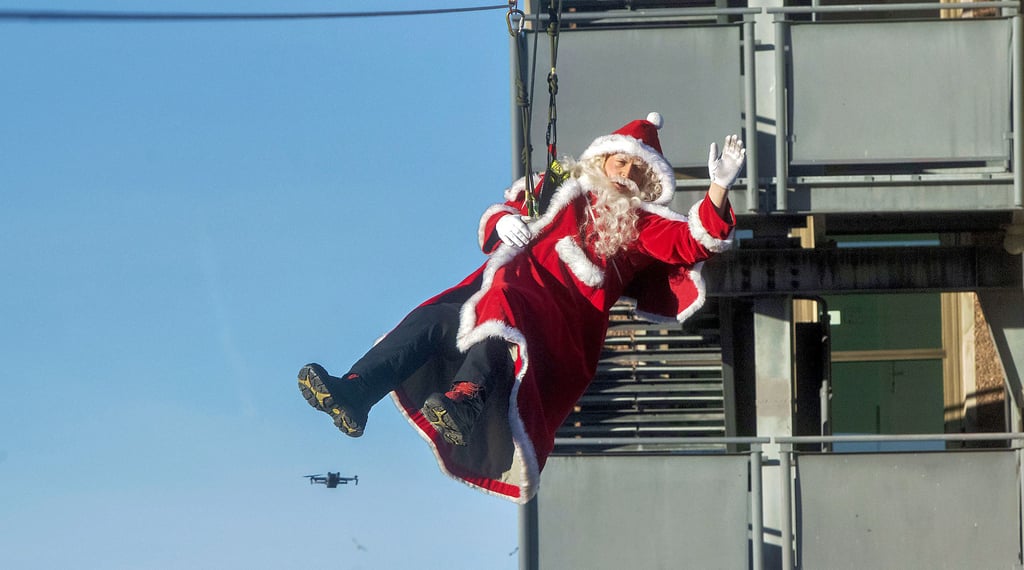 Der Nikolaus seilt sich zu den wartenden Kindern vor dem Städtischen Klinikum ab.