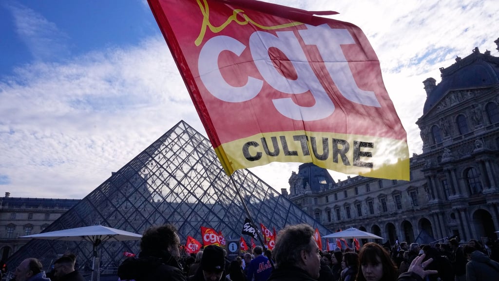 Angestellte zeigen eine Flagge der Gewerkschaft CGT vor dem Louvre, nachdem sie für einen Streik gestimmt haben.