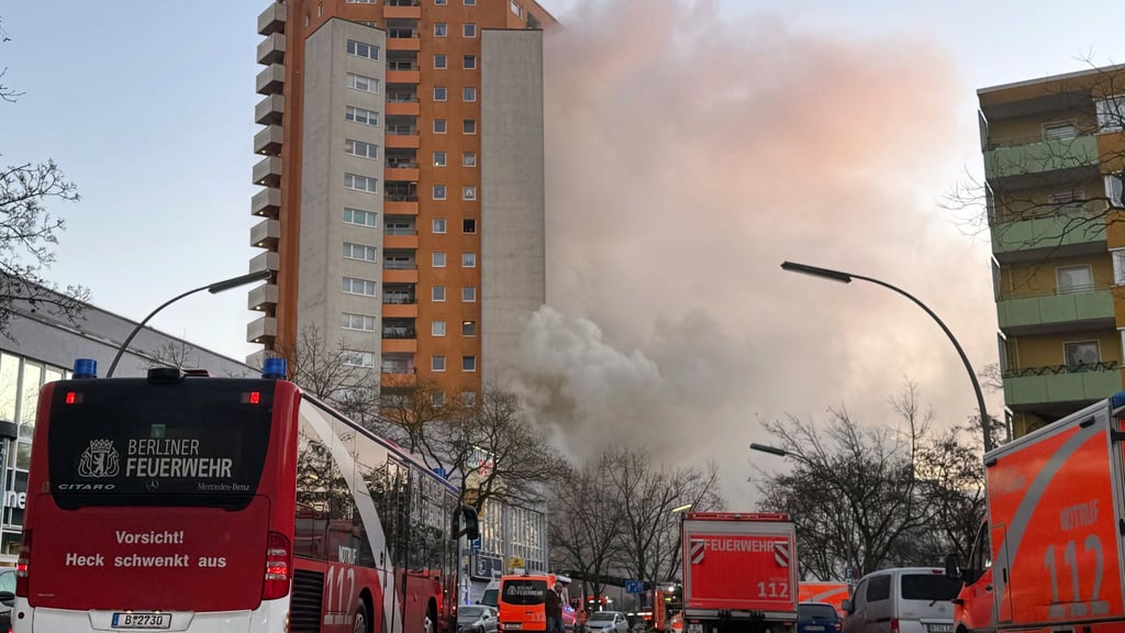 Rettungskräften vor dem brennenden Hochhaus in Berlin-Spandau.