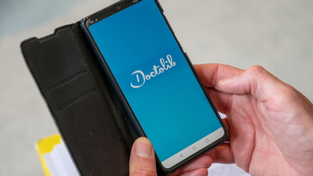 Ein Mann öffnet auf einem Smartphone die Doctolib-App. (Symbolbild)