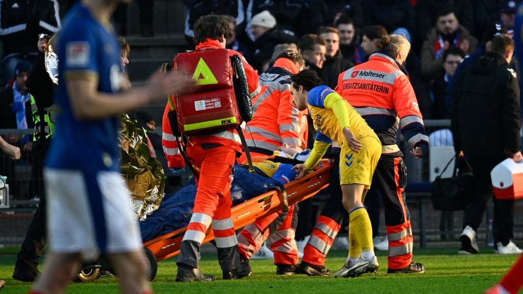 Paderborns Spieler Calvin Brackelmann wird nach einer Verletzung von Sanitätern auf einer Trage vom Spielfeld gebracht.