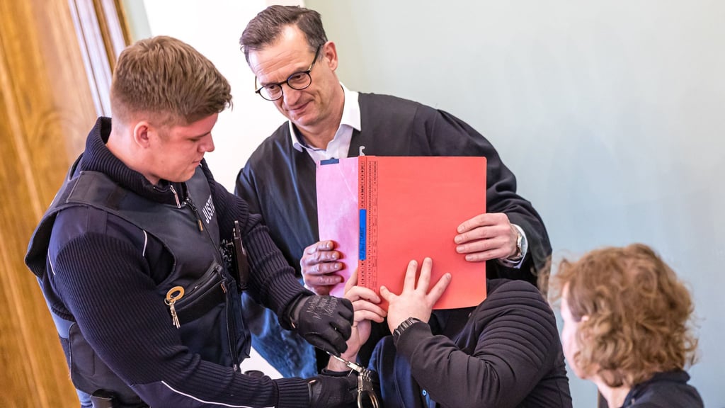 Auch am zweiten Verhandlungstag im Prozess um einen tödlichen Polizei-Einsatz gegen Autodiebe verdeckt der Angeklagte sein Gesicht.