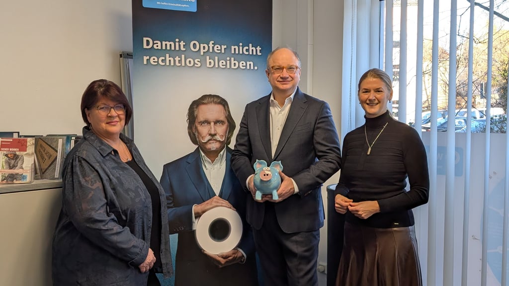 Marc Melzer vom Vorstand der Investitionsbank übergibt Kerstin Godenrath (r.), Landesvorsitzende vom Weissen Ring, eine Spende.