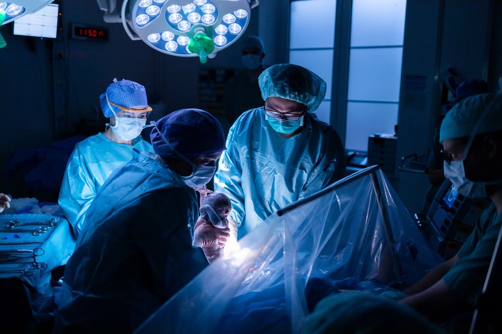 Die sanfte Kaisergeburt ermöglicht es, den Geburtsmoment auch bei einem Kaiserschnitt bewusst mitzuerleben - hier wird das Neugeborene behutsam aus dem Mutterleib gehoben.