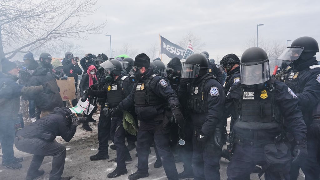 Bundesbeamte der Einwanderungsbehörde ICE sind hier bei einer Demonstration in Minneapolis zu sehen.