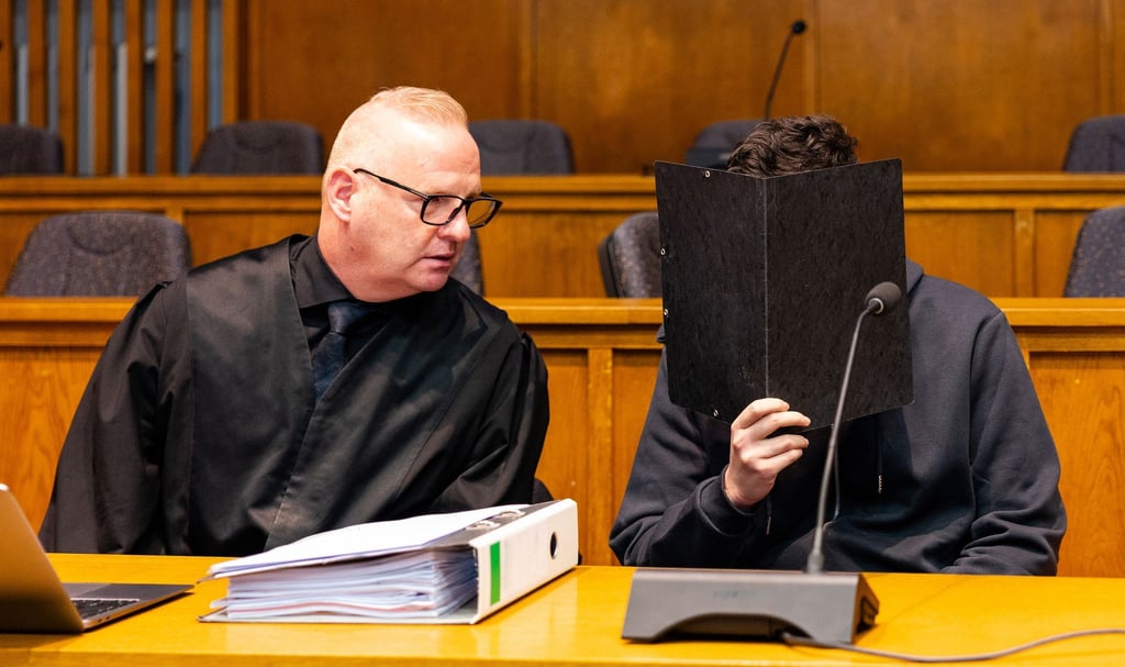 Der wegen Mordes angeklagte junge Mann sitzt neben seinem Verteidiger Michael Rehberger im Landgericht Saarbrücken.