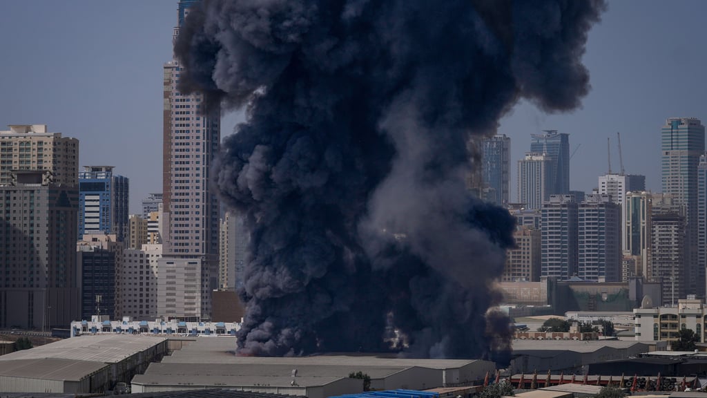 Eine schwarze Rauchwolke steigt aus einem Lagerhaus im Industriegebiet von Sharjah City in den Vereinigten Arabischen Emiraten auf, nachdem über iranische Angriffe berichtet wurde.