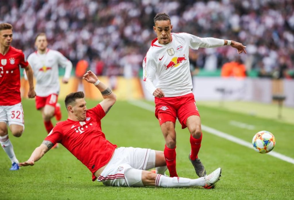 Leipzig s Yussuf Poulsen (R) vies with Bayern Munich s Niklas Suele (bottom) during the German Cup final between RB Leipzig and FC Bayern Munich in Berlin, capital of Germany