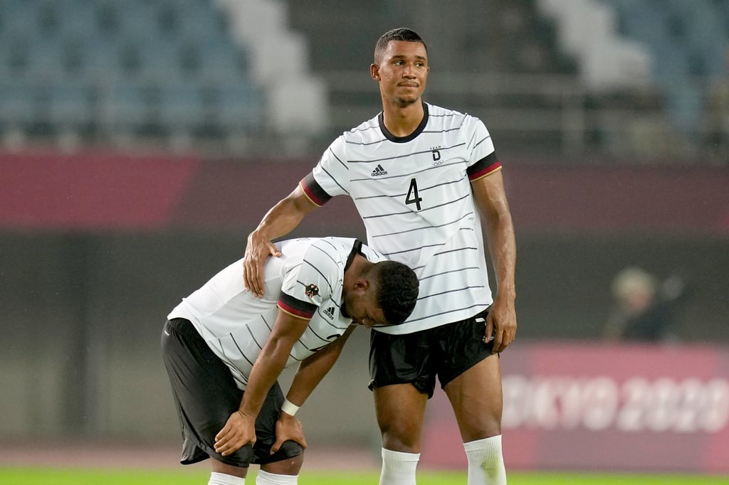 Felix Uduokhai trösten Deutschlands Eigentorschützen Benjamin Henrichs (l.) nach dem Olympia-Aus.