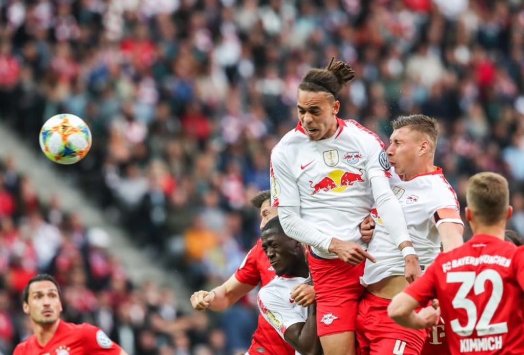 Leipzig s Yussuf Poulsen (up L) takes a header during the German Cup final between RB Leipzig and FC Bayern Munich in Berlin, capital of Germany